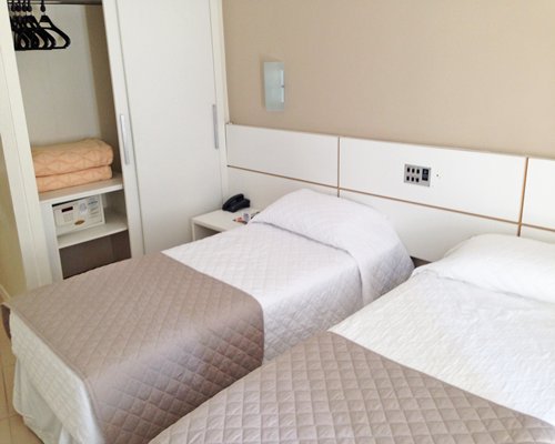 A well furnished bedroom with two twin beds.