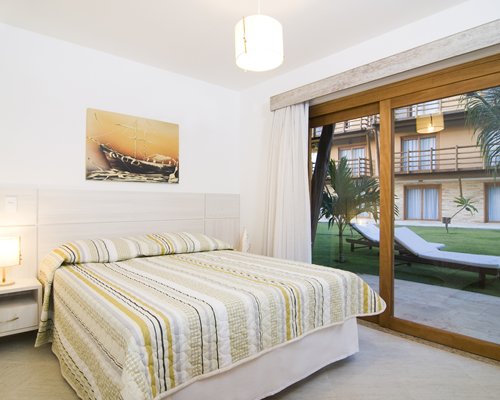 A well furnished bedroom with an outside view.