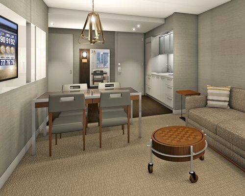 A well furnished living room with an open plan kitchen and dining area.