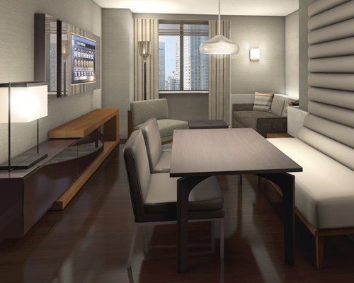 A well furnished living room with a dining area.