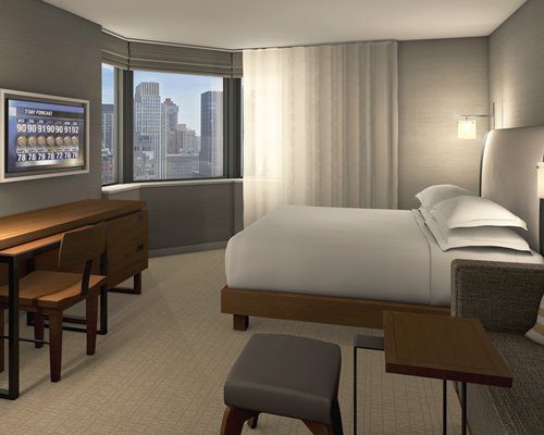 A well furnished bedroom with an outside view.