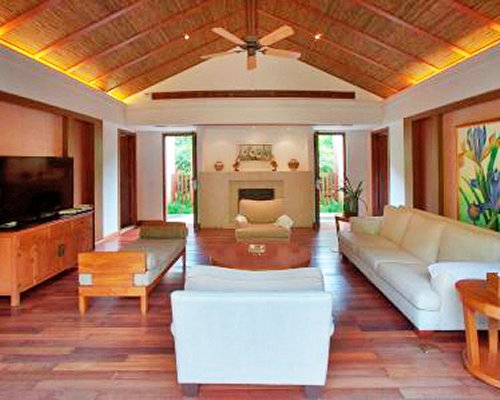 A well furnished living room with a television and fireplace.
