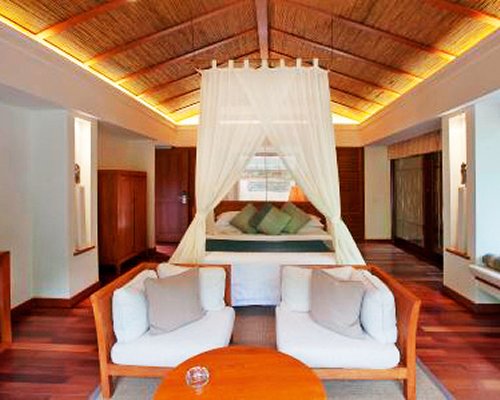 A well furnished living room with a queen bed.