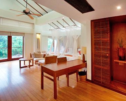 A well furnished bedroom with a balcony.
