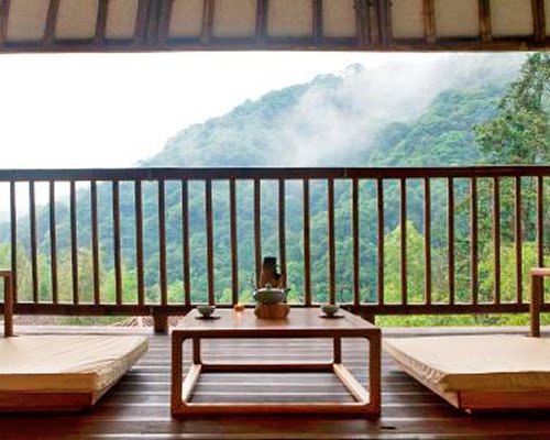 A balcony overlooking green mountains.