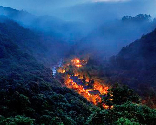 A view of the resort property surrounded by mist and hills.