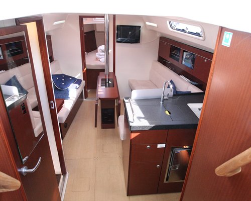 A kitchen and living area inside a boat cabin.