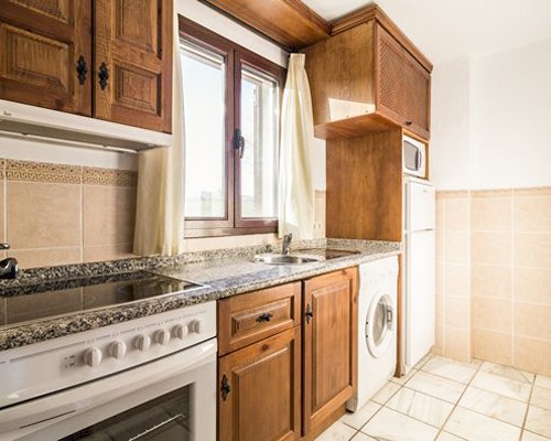 A well equipped kitchen with a microwave oven.