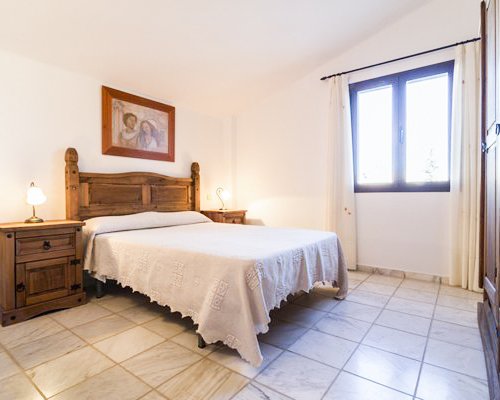 A well furnished bedroom with a double bed.
