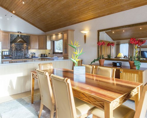 A well furnished dining area alongside kitchen.