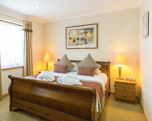 A well furnished bedroom with an outside view.