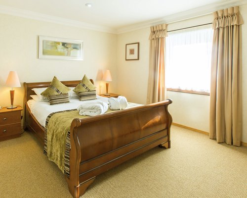 A well furnished bedroom with an outside view.