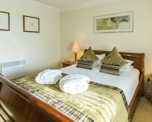 A well furnished bedroom with a double bed.