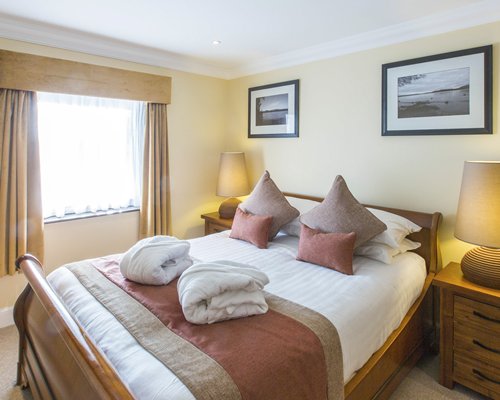 A well furnished bedroom with an outside view.