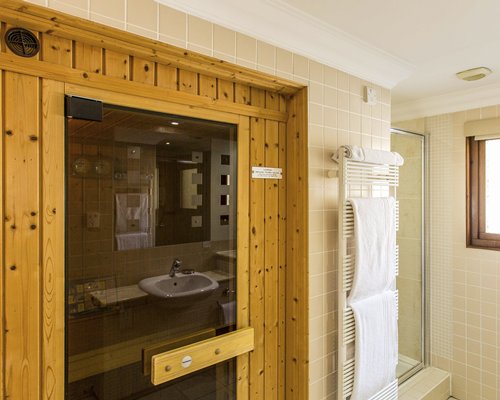 A bathroom with a shower and single sink vanity.