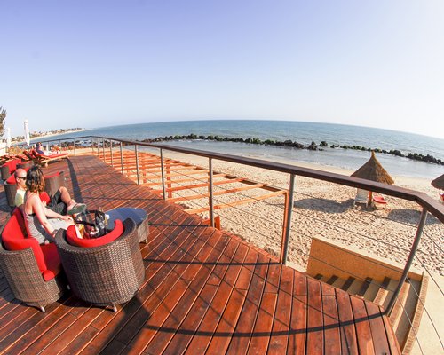 Balcony with patio alongside the ocean.