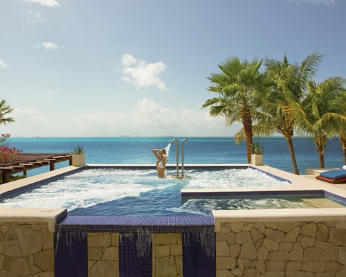 A woman enjoying in an outdoor hot tub.