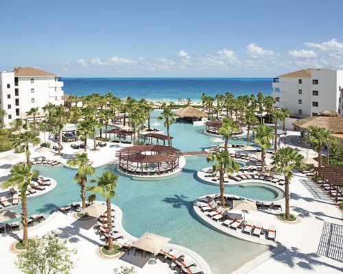 An outdoor swimming pool with chaise lounge chairs.