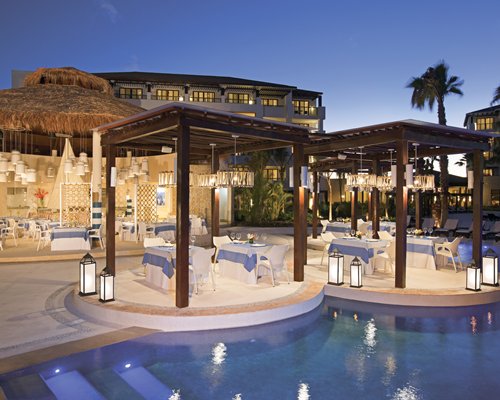An outdoor swimming pool alongside a restaurant.