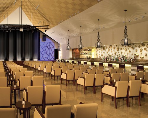 An indoor theater with a stage and bar counter.