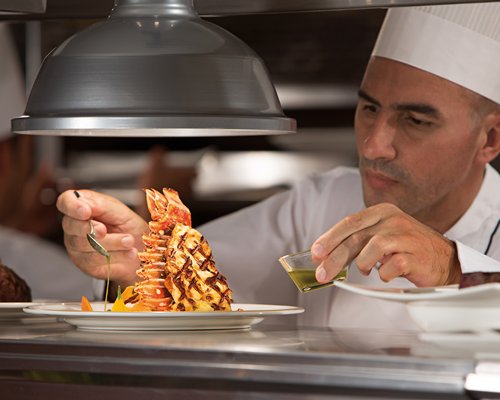 A chef preparing a food item.