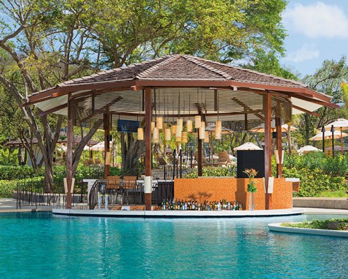 An outdoor swimming pool with a poolside bar.