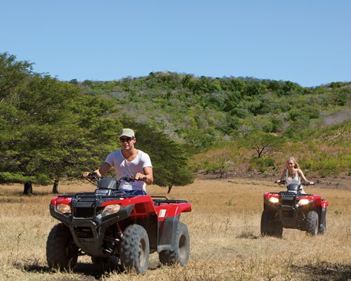 A view of two people riding ATV's.
