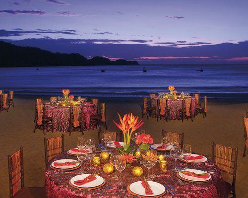 Outdoor restaurant at the beach alongside the ocean.