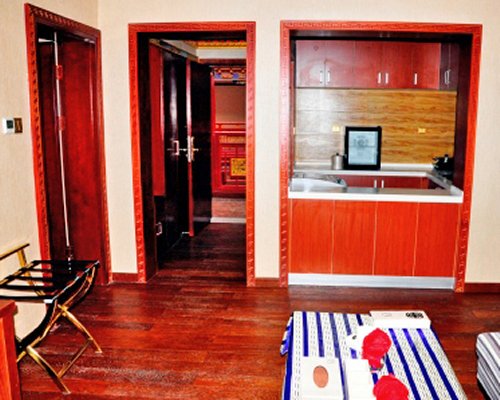 A well furnished living room alongside kitchen.