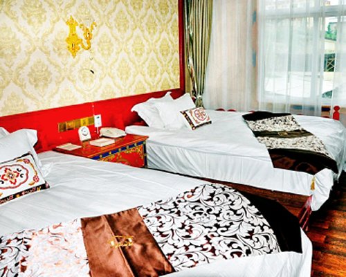 A well furnished bedroom with two twin beds.