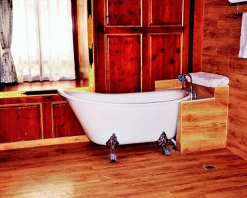 A clawfoot tub in a wooden bathroom.