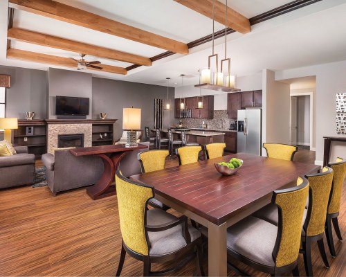LIVING ROOM WITH A TELEVISION OPEN PLAN KITCHEN AND DINING AREA.
