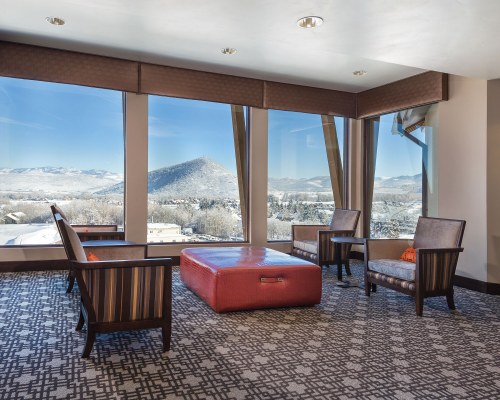 A WELL FURNISHED INDOOR LOUNGE AREA WITH AN OUTSIDE VIEW.
