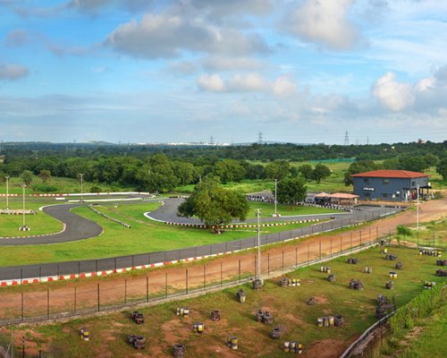 An outdoor track alongside a well maintained lawn.