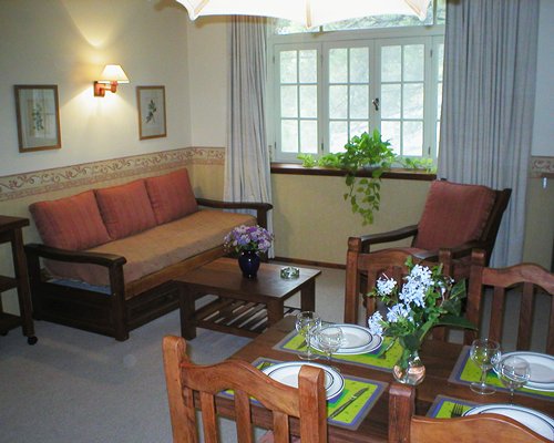 A well furnished living room with a dining area.