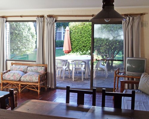 A well furnished living room with a television and patio.