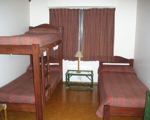 A well furnished bedroom with bunk bed and a twin bed.
