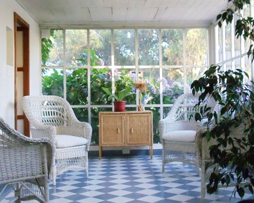 Resort lounge area with patio furniture and outside view.