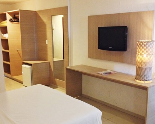 A well furnished bedroom with a television.