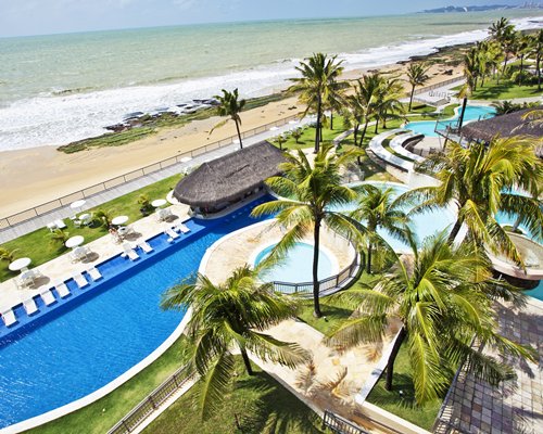 Multiple outdoor pools and a hot tub alongside the beach.