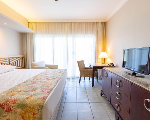 A well furnished bedroom with two beds and an outside view.