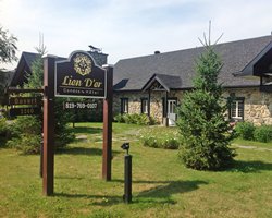 An exterior view of the hotel and the signboard.