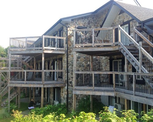 Scenic exterior view of Condo Hotel le Lion D'Or with multiple balconies and stairways.