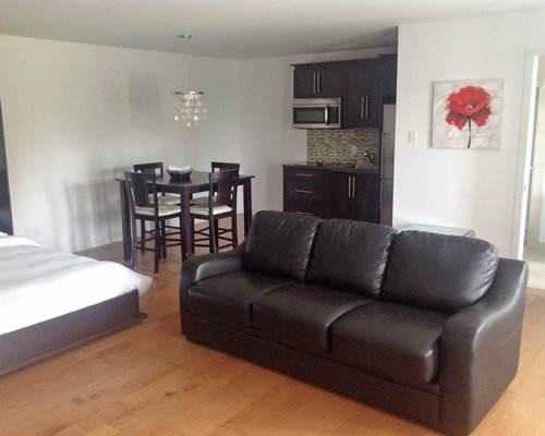 A well furnished living room with an open plan kitchen and dining area.