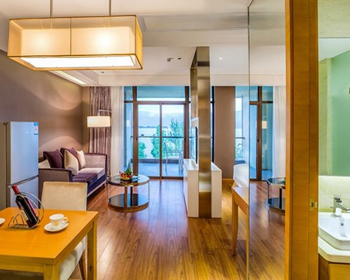A well furnished living room with dining area and an outside view.