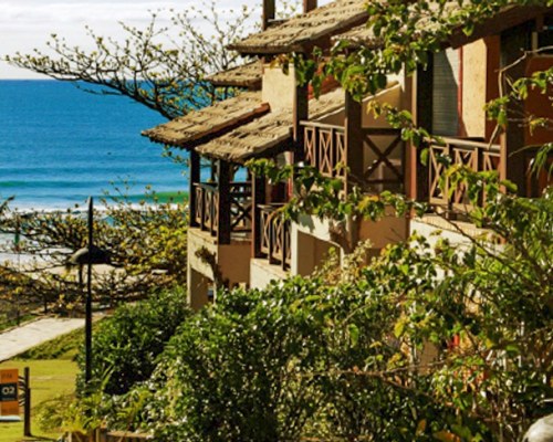 SCENIC EXTERIOR VIEW OF RESORT UNIT ALONGSIDE THE OCEAN.