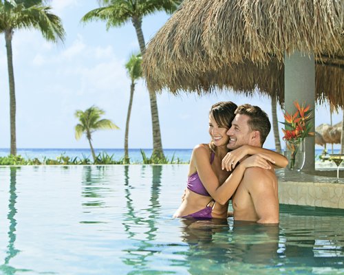 A couple in an outdoor swimming pool.