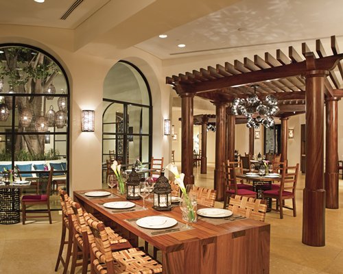 An indoor fine dining area at the resort with an outside view.