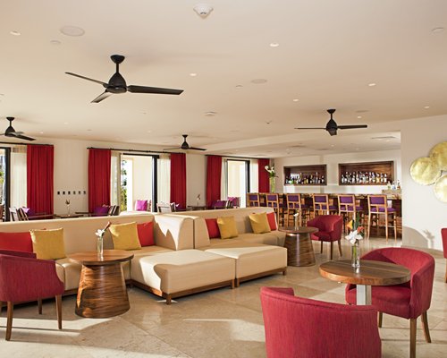 An indoor bar at the resort with an outside view.