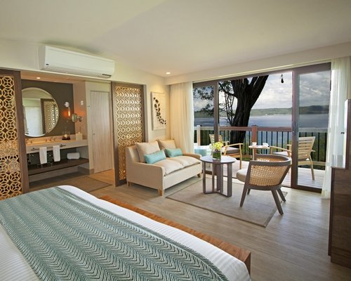 A well furnished living room with bedroom and balcony.